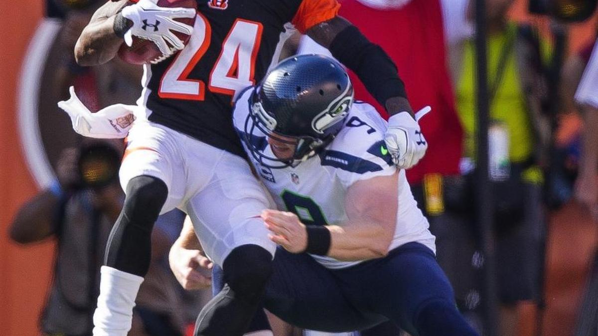 
Seahawks punter Jon Ryan tackles the Bengals' Adam Jones during the fourth quarter on Sunday. Ryan takes issue with former NFL coach Brian Billick’s statement that punters are not football players.
