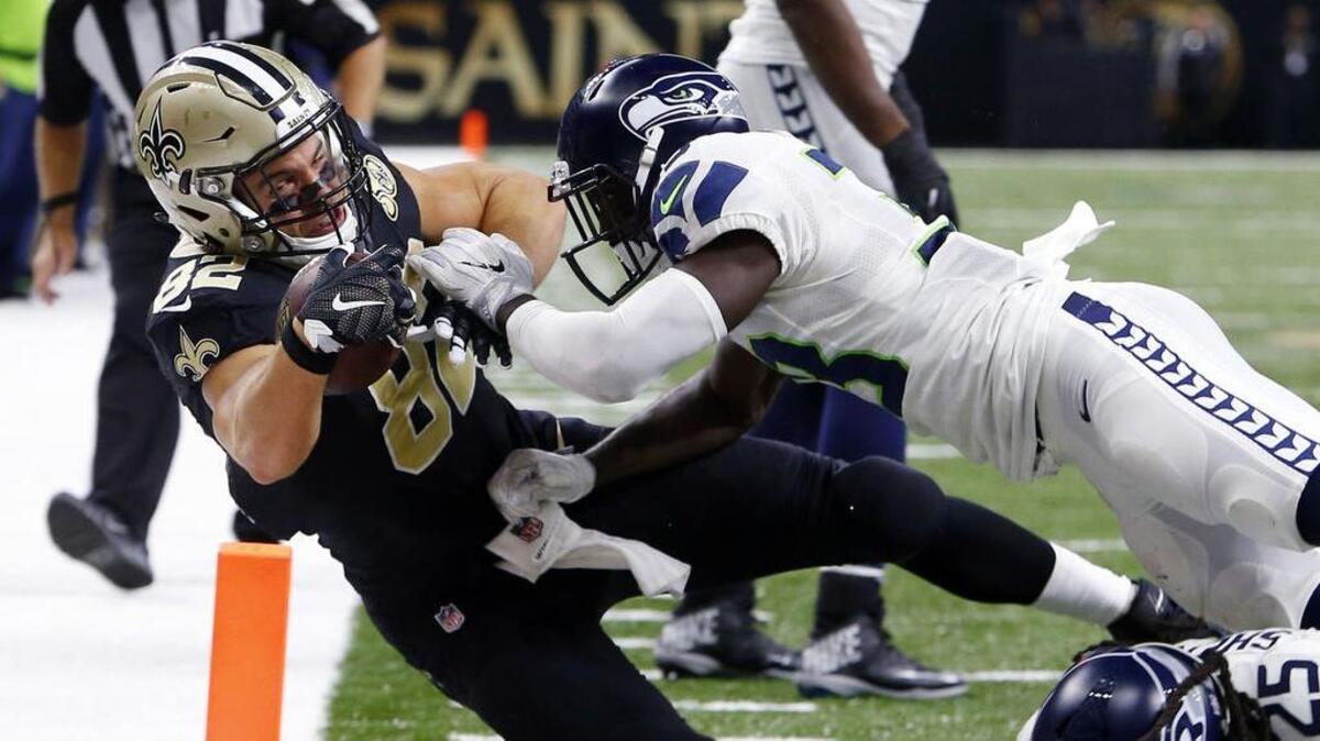 New Orleans’ Coby Fleener, left, is stopped at the goal line by Seattle’s defense, which has played on 162 snaps in the past two games.