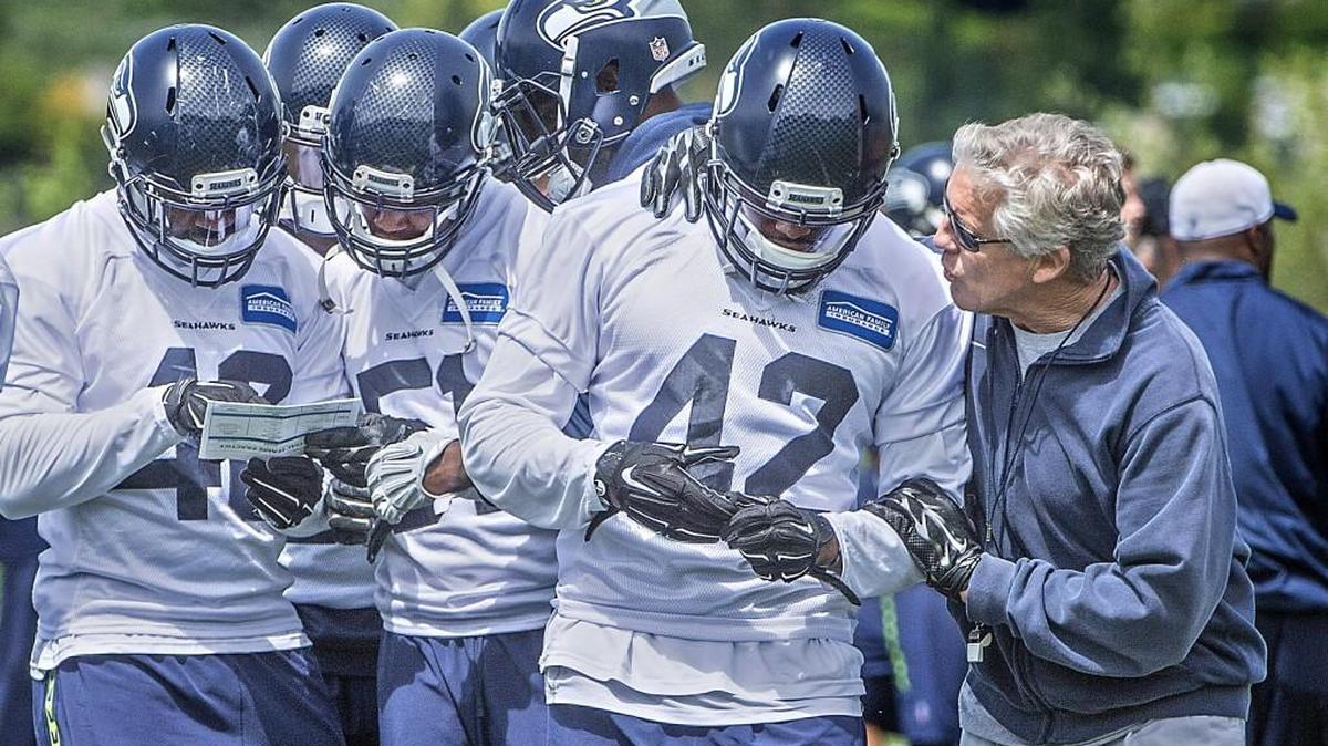 Defensive end candidate David Perkins, gets coached up by Pete Carroll at the Virginia Mason Athletic Center, the Seattle Seahawks training facility, in Renton during OTA's.