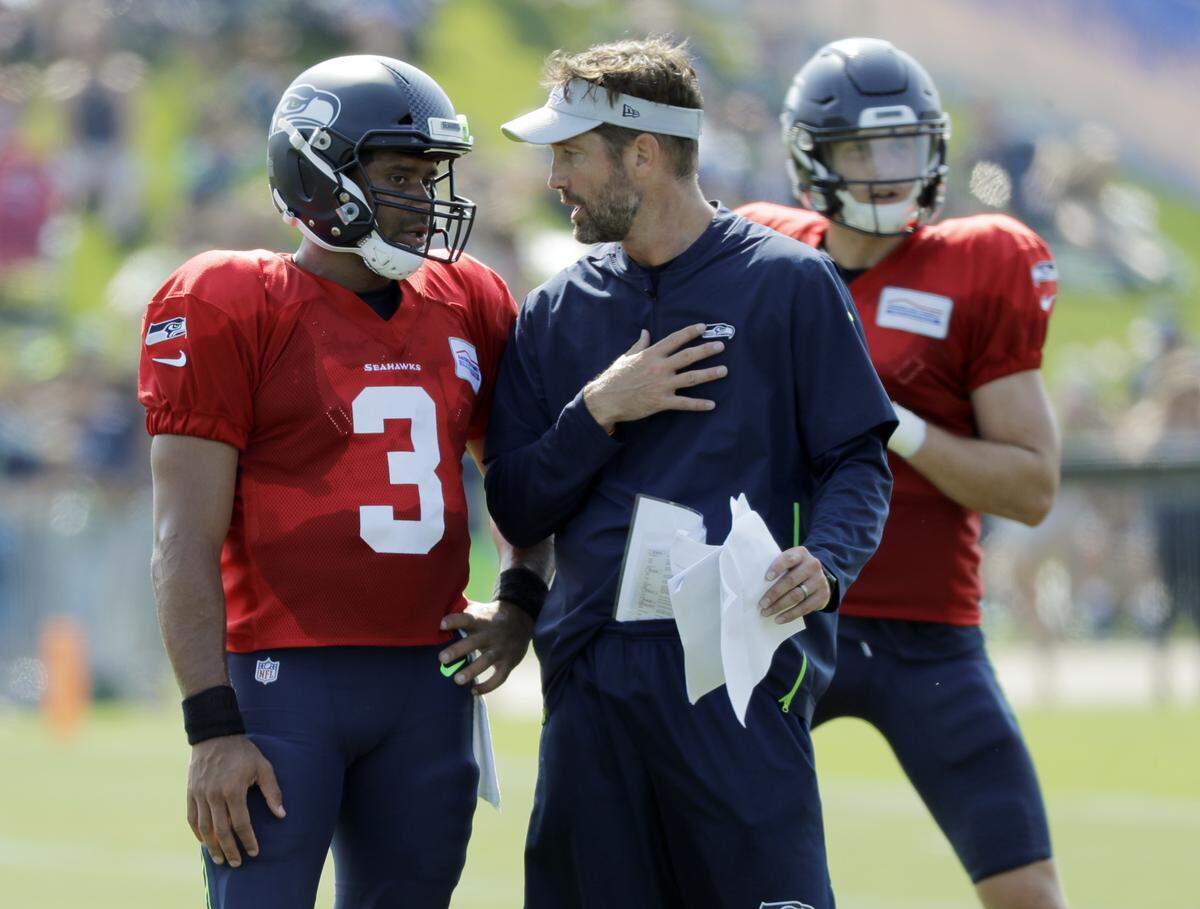 Offfensive coordinator Brian Schottenheimer (right) says he didn’t do a good enough job mixing in enough runs in his first game as the Seahawks’ play caller last weekend in the loss at Denver. Calling more runs Monday night in game two at Chicago should help reduce the pressure quarterback Russell Wilson (3) has been getting the last couple years from defenses who mostly ignore the thought Seattle will hand the ball off to running backs.