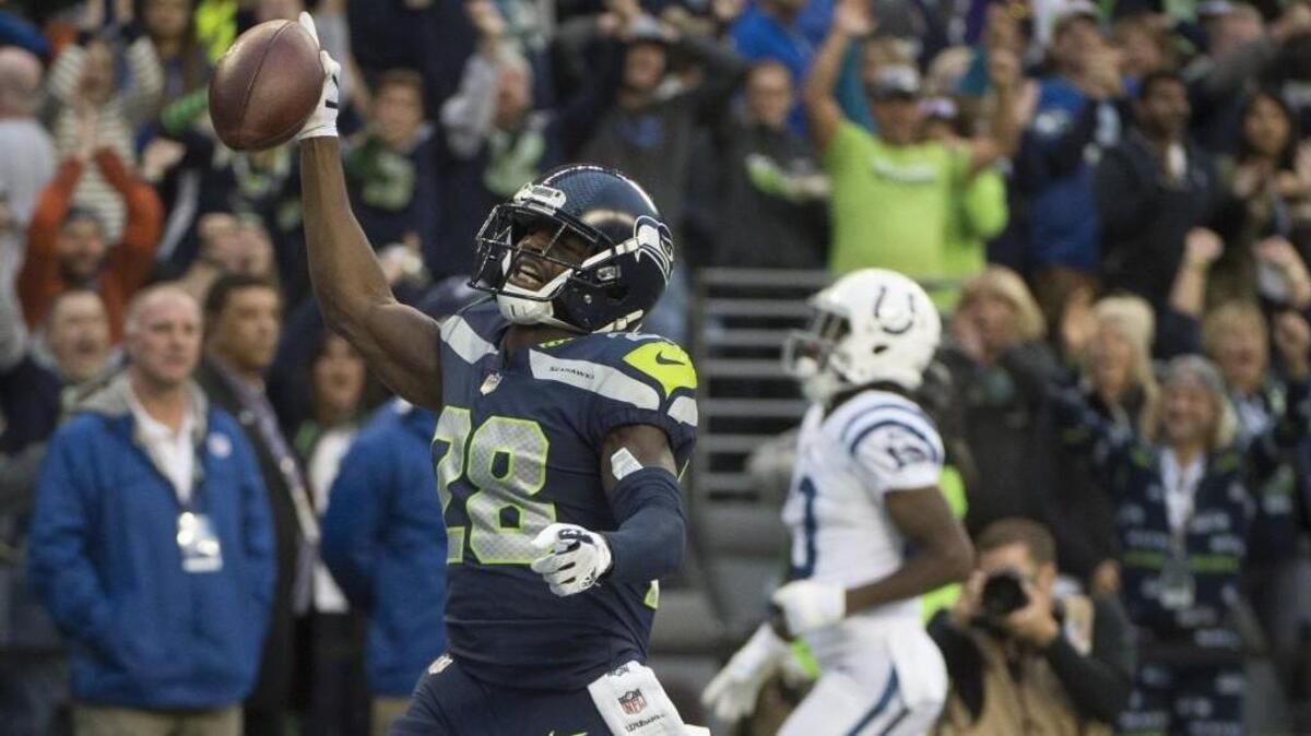 Seahawks corner back Justin Coleman (28) reacts after intercepting a pass and returning it for a touchdown in the second quarter.