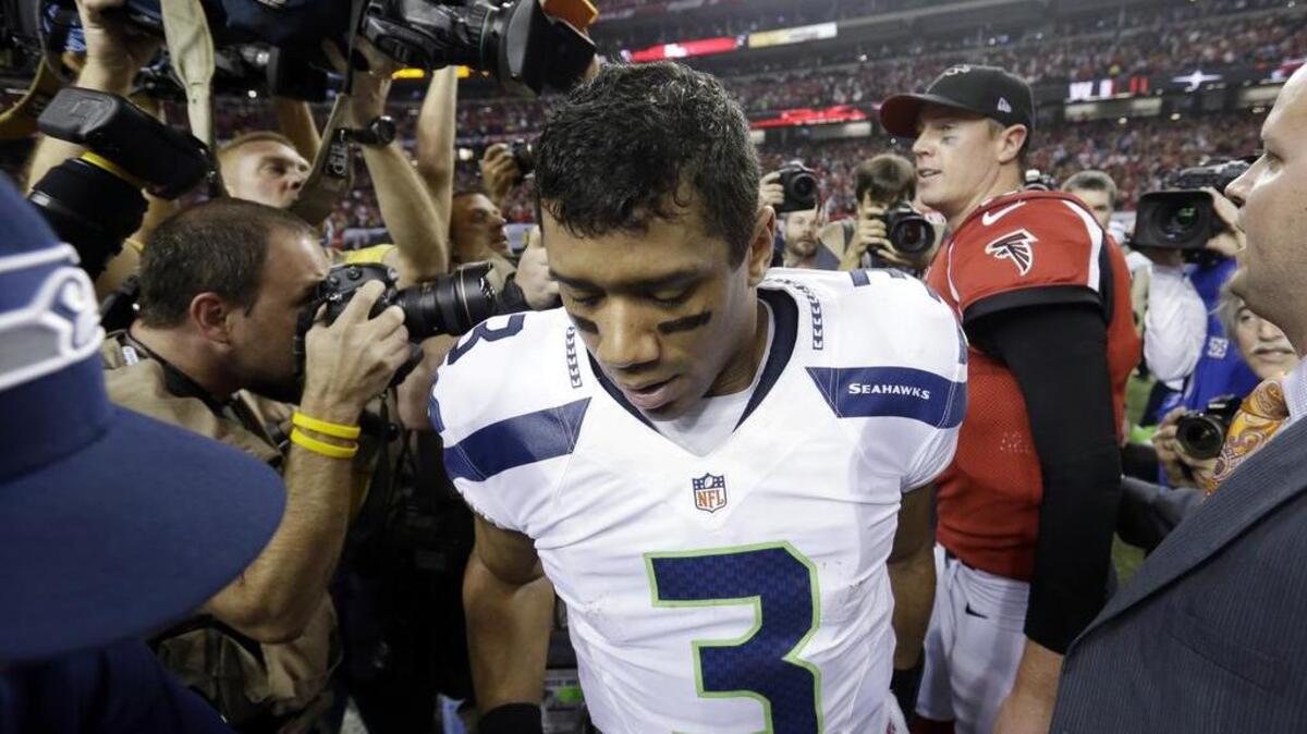 Seahawks quarterback Russell Wilson (3) leaves the Georgia Dome field after shaking hands with Falcons quarterback Matt Ryan after Atlanta edged Seattle, 30-28, in a playoff game in January 2013.