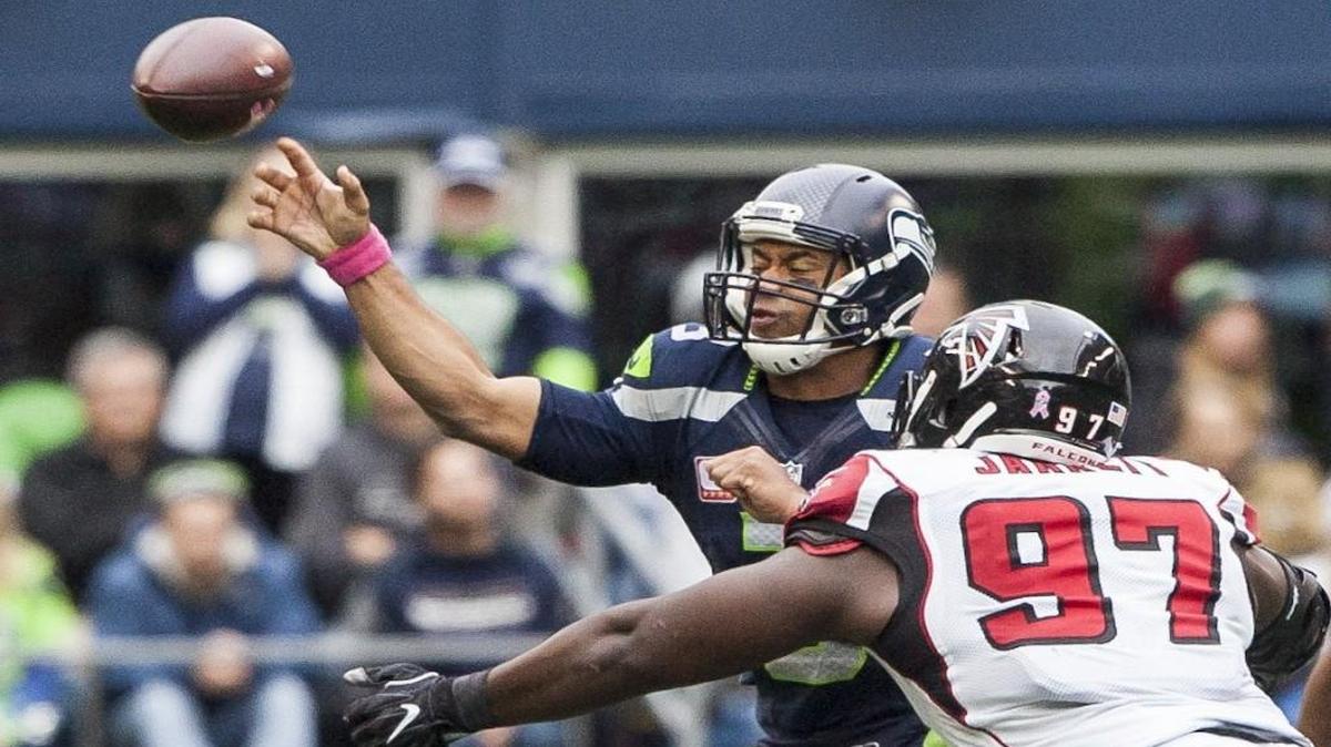 Seahawks quarterback Russell Wilson throws under pressure Sunday from Falcons defensive lineman Grady Jarrett in the third quarter of Seattle’s 26-24 win at CenturyLink Field in Seattle.