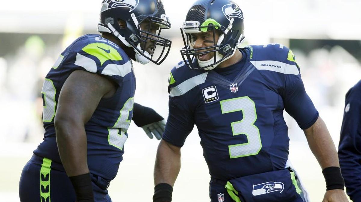 Seahawks quarterback Russell Wilson, right, and center Patrick Lewis talk before a game against the 49ers earlier this season. Ever since Lewis was inserted into the starting lineup in Week 6, the Seahawks’ offensive line has vastly improved.
