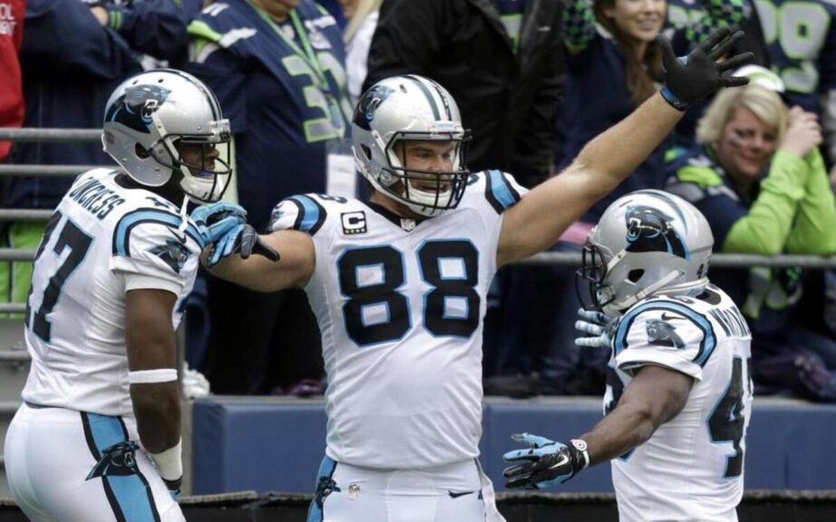 Carolina Panthers tight end Greg Olsen (88) celebrates with teammates Fozzy Whittaker, right, and Devin Funchess, left, on Oct. 18 after Olsen caught the go-ahead touchdown pass with 32 seconds left against Seattle. The Panthers won 27-23 in Seattle.