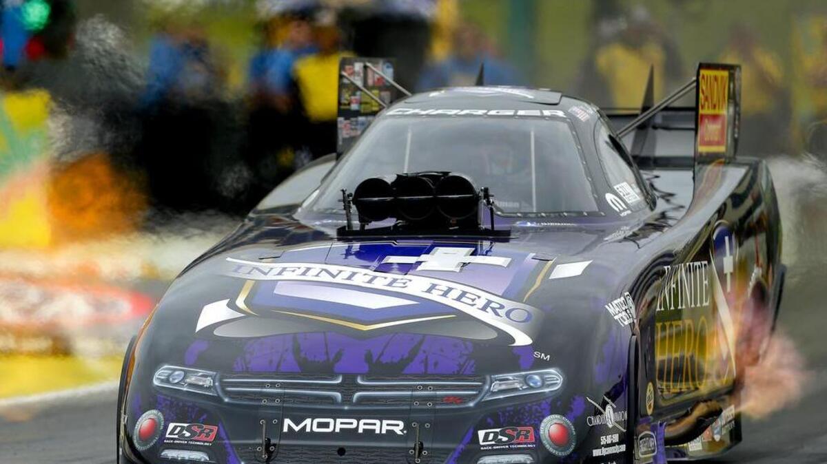 
Funny Car driver "Fast" Jack Beckman accelerates down the track during the quarterfinals of the 2015 NHRA Kansas Nationals on May 24, at Heartland Park in Topeka, Kan. Beckman won the Kansas Nationals over John Force with a time of 3.982 seconds.
