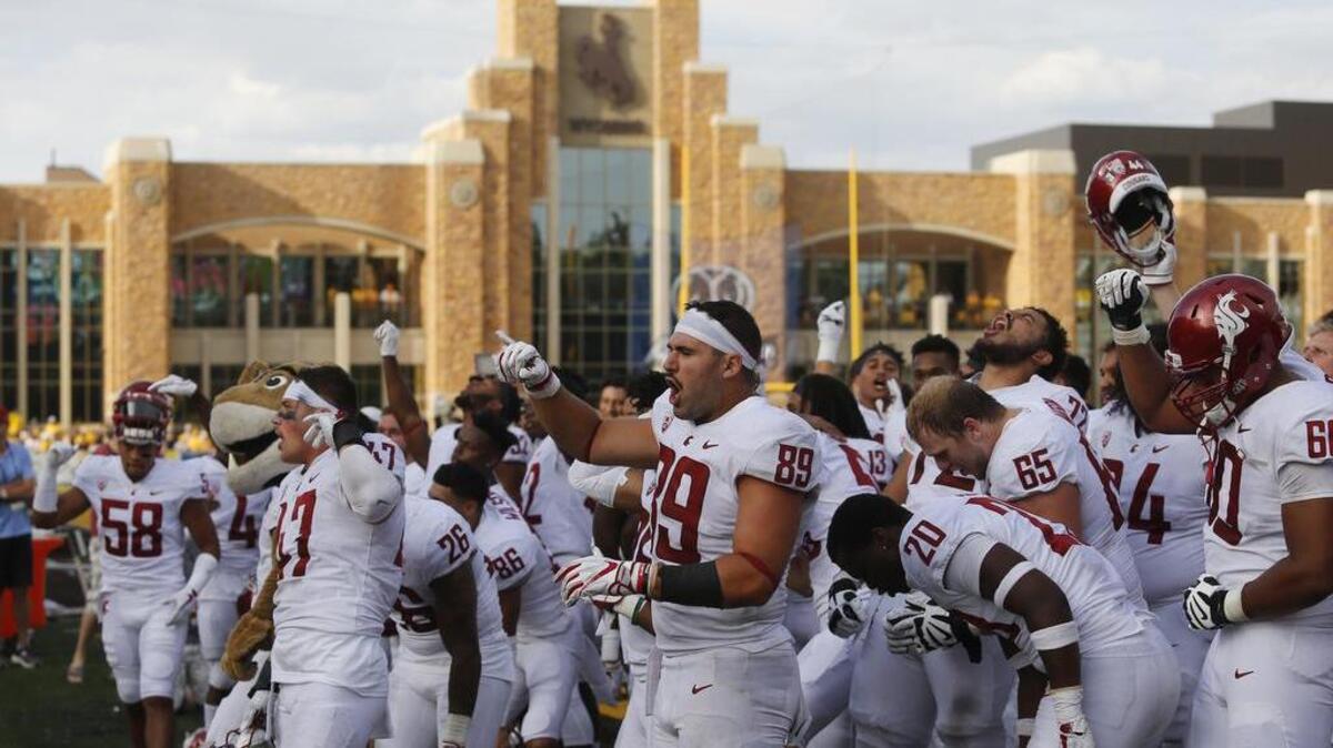 Washington State players recognize their fans in the stands Saturday, Sept. 1, 2018, at War Memorial Stadium in Laramie, Wayo. Washington State defeated Wyoming 41-19 in an NCAA college football game. (Alan Rogers/The Casper Star-Tribune via AP)