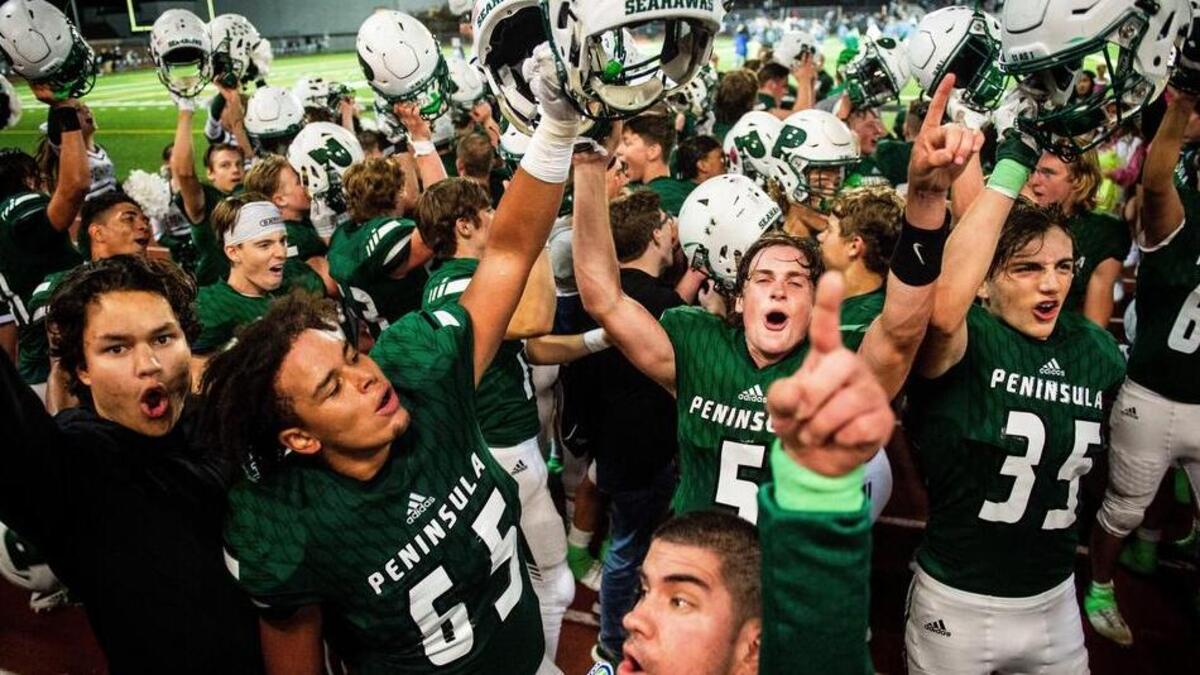 Peninsula players celebrate after the win. Peninsula High School played Timberline High School in a football game at Roy Anderson Field in Purdy, Wash., on Thursday, Sept. 27, 2018.