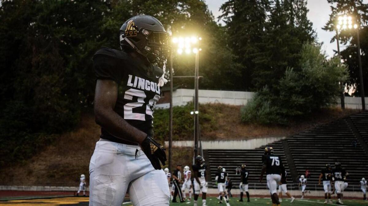 Lincoln’s Julien Simon (24) is all smiles after picking off a pass and scoring a touchdown in the first quarter. Lincoln High School played Camas High School in a football game at the Lincoln Bowl in Tacoma, Wash., on Friday, Aug. 31, 2018.