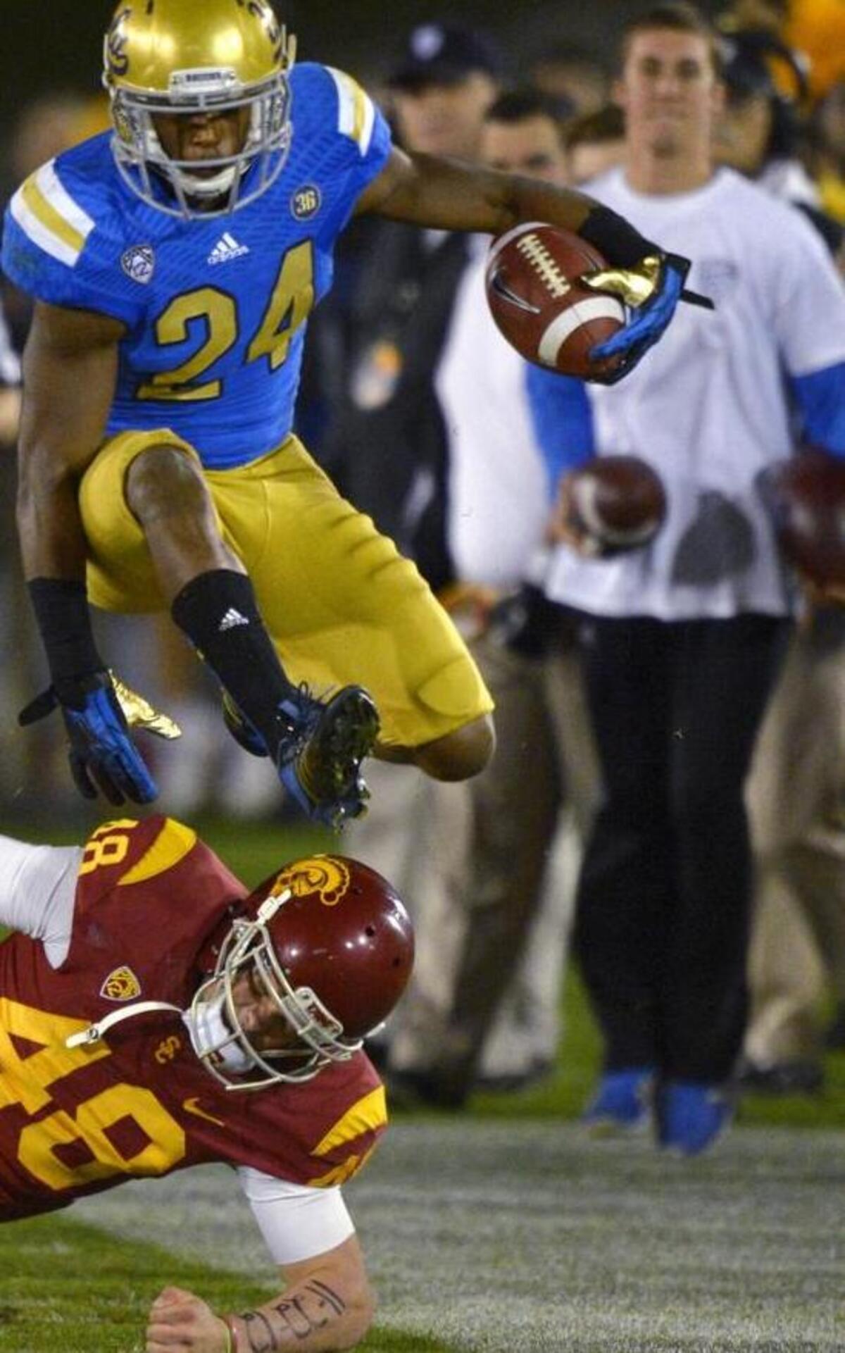 Running back Paul Perkins (24) and the UCLA Bruins are looking for their fourth consecutive win over USC.