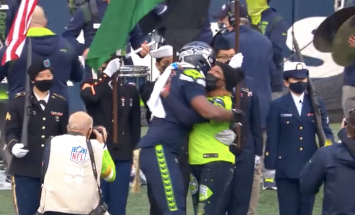 Seahawks defensive end Carlos Dunlap hugs his mother, 11-year U.S. Army Reserve dental specialist Dr. Diana-Ross Jackson, during the third quarter of Seattle’s game against the Arizona Cardinals at Lumen Field Sunday, Nov. 21, 2021. It was the Seahawks’ annual Salute to Service game.