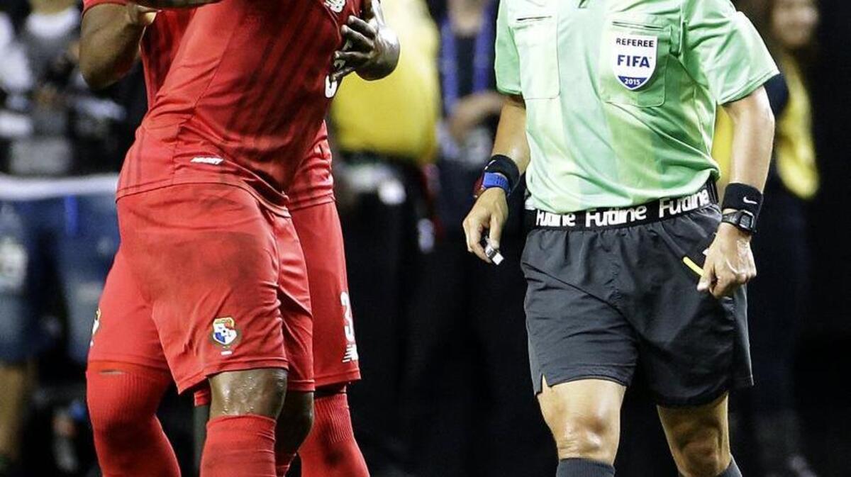 
Referee Mark Geiger, right, is confronted by Panama's Roman Torres, center, and Harold Cummings, left, after he gave a red card to teammate Luis Tejada, not pictured, during the first half of a CONCACAF Gold Cup semifinal playoff soccer game against Mexico Wednesday, July 22, 2015, in Atlanta.

