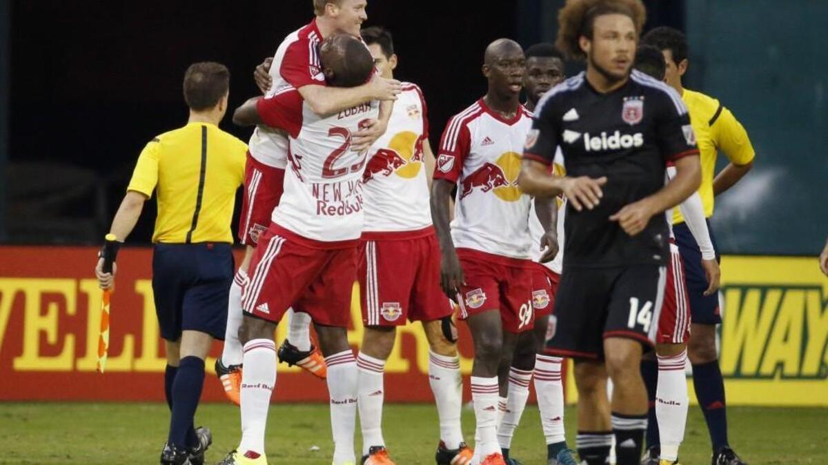 New York defender Ronald Zubar (23) picks up midfielder Dax McCarty after the Red Bulls beat D.C. United, 1-0, on McCarty’s second-half goal Sunday.