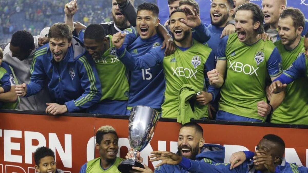 Clint Dempsey, holding the trophy after the Sounders won the MLS Western Conference final against the Houston Dynamo, is ulta-motivated to win an MLS Cup this season.