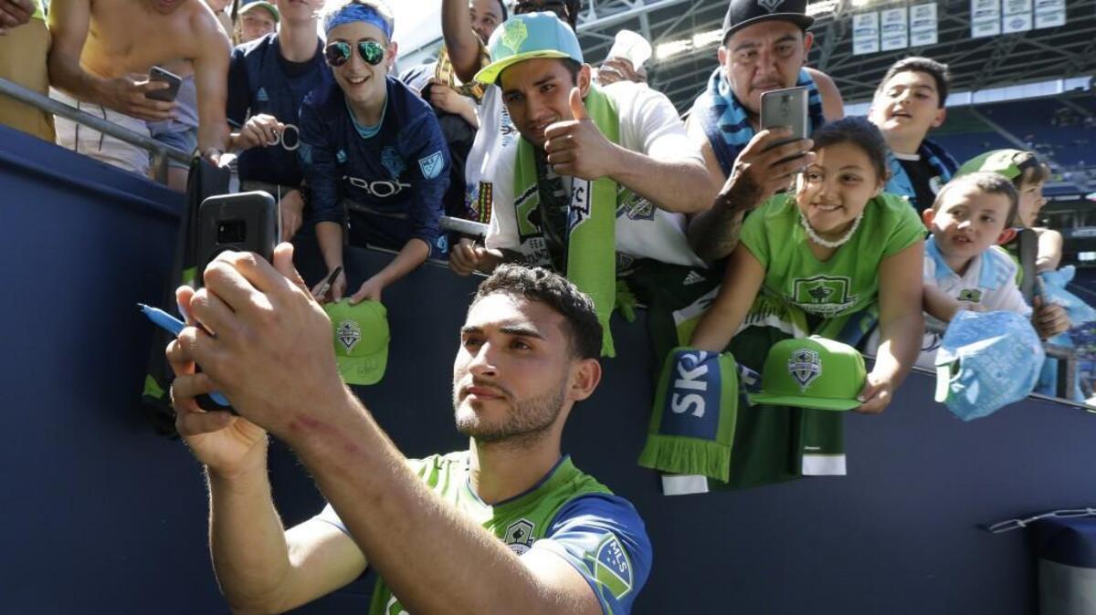 Seattle Sounders midfielder Cristian Roldan takes a selfie with fans after his goal in the first half gave the Sounders a 1-0 win over the Portland Timbers in May. Roldan was called up to be a part of the U.S. roster in the upcoming Gold Cup.