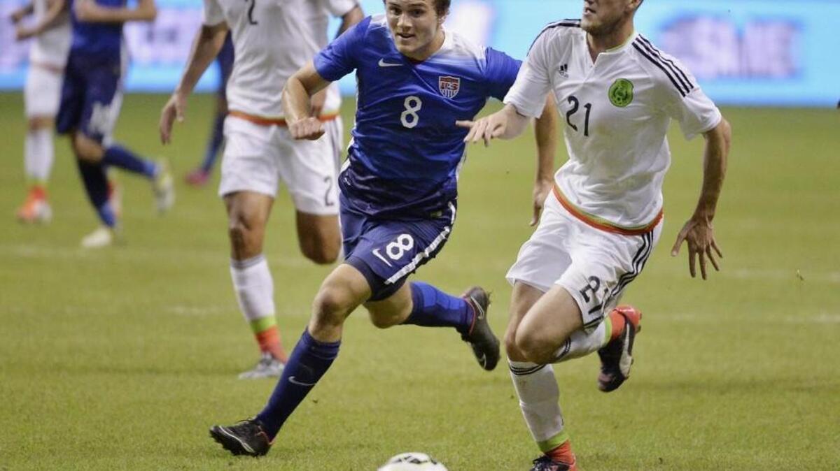 U.S. defender Jordan Morris (8) chases the ball down against Mexico defender Hiram Mier during an exhibition match on April 15 in San Antonio. Morris, a Mercer Island native, may possibly land in Seattle with the Sounders.