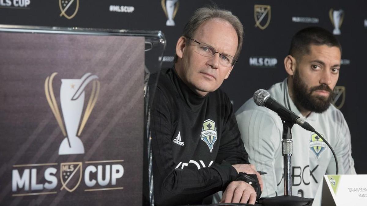 Seattle Sounders head coach Brian Schmetzer, left, and forward Clint Dempsey listen to a question during a news conference in Toronto. The Sounders face Toronto FC in the MLS Cup final on Saturday.