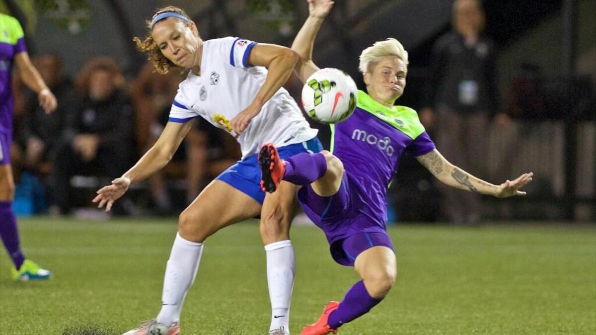 FC Kansas City midfielder Lauren Holiday, left, and Seattle Reign FC midfielder Jessica Fishlock collide during the first half of the NWSL soccer championship match Oct. 1 in Portland. Kansas City won, 1-0.