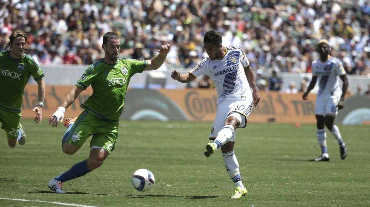 
Galaxy's Giovani Dos Santos, right, shoots under pressure by the Sounders’ Zach Scott during a match in August. Scott has made more than 100 MLS appearances with the Sounders, who he has played with since 2002. 
