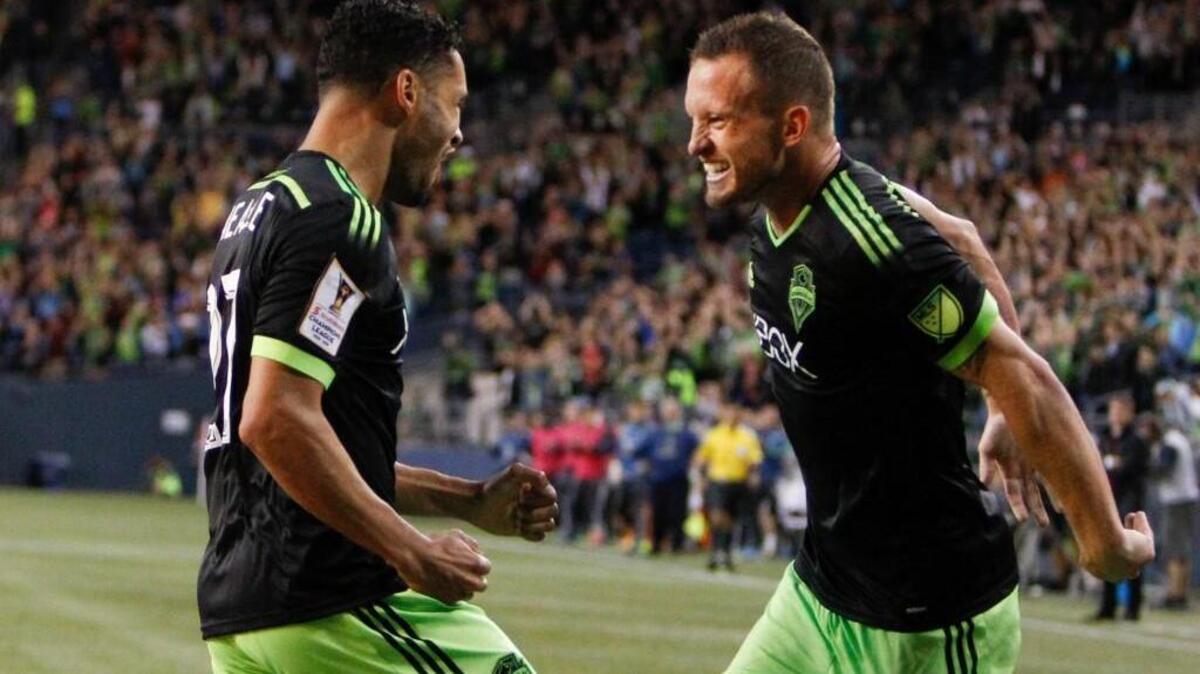 
Seattle Sounders midfielder Lamar Neagle, left, celebrates with Chad Barrett after Neagle scored a goal against the Vancouver Whitecaps during the first half of a CONCACAF Champions League soccer match, Wednesday, Sept. 23, 2015, in Seattle.
