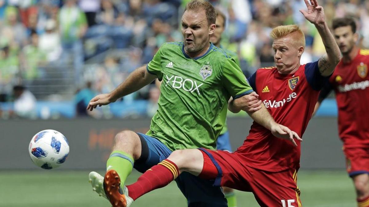 Seattle Sounders defender Chad Marshall, left, works for the ball with Real Salt Lake defender Justen Glad (15) during the second half of an MLS soccer match Saturday, May 26, 2018, in Seattle. Real Salt Lake won 1-0. (AP Photo/Ted S. Warren)