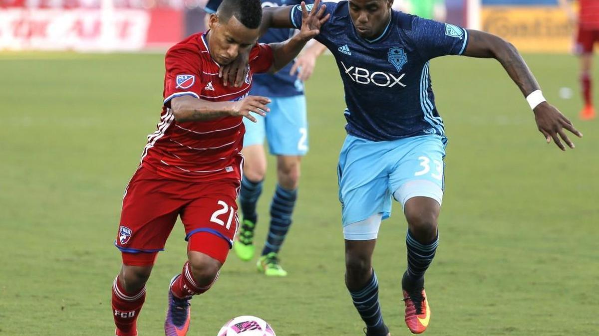 FC Dallas midfielder Michael Barrios (21) and Sounders defender Joevin Jones (33) compete for the ball on Oct. 16 during an match in Frisco, Texas. An offseason trade acquisition from Chicago, Joevin Jones has given Seattle an offensive spark at left back.