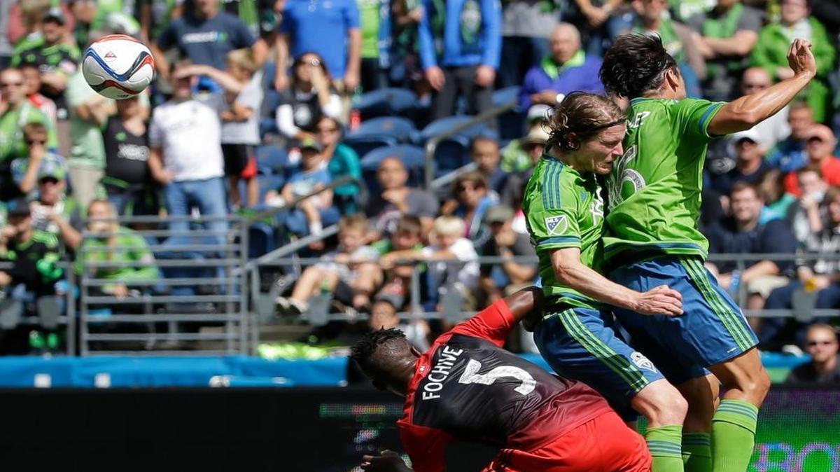 
Sounders forward Nelson Valdez, right, and midfielder Erik Friberg, center, fight for the ball Sunday against Portland. With Clint Dempsey close to returning, Valdez’s starting spot may be in jeopardy.
