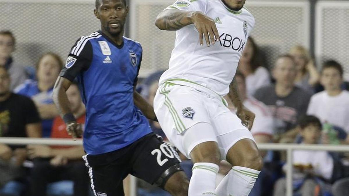 
Sounders defender Roman Torres, right, jumps for a ball Saturday against the Earthquakes in San Jose. Torres injured his knee during the game and will miss the rest of the season.
