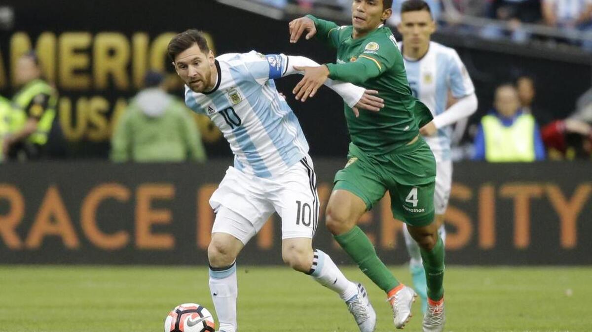 Argentina's Lionel Messi, left, and Bolivia's Diego Bejarano fight for the ball during their Copa America Centenario Group D match on Tuesday at CenturyLink Field. Messi, who’s been getting back into shape after missing time with a quad injury, was brought on to start the second half.