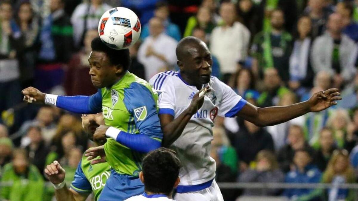 Seattle Sounders forward Oalex Anderson, left, goes for a header against Montreal Impact’s Hassoun Camara on Saturday during the second half in Seattle. The Sounders won 1-0.