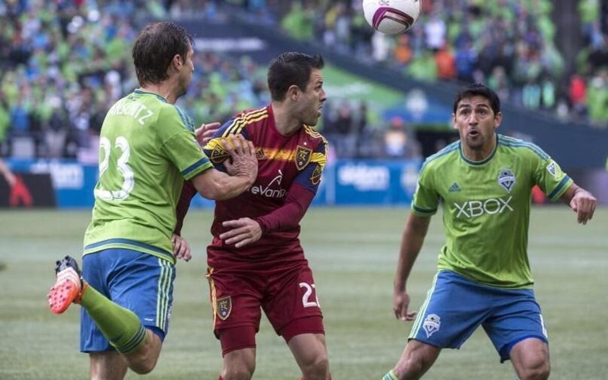 Sounders defenders Andreas Ivanschitz left, and Leo Gonzalez apply pressure against Real Salt Lake on Sunday. Thanks to the Sounders’ 3-1 victory, they will play host to the Los Angeles Galaxy in the playoffs on Wednesday.