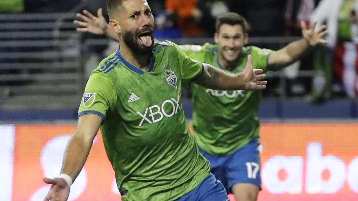 FILE - In this March 7, 2018, file photo, Seattle Sounders forward Clint Dempsey, left, celebrates with defender Will Bruin, right, after Dempsey scored a goal against Guadalajara during the second half of a CONCACAF Champions League soccer match in Seattle. Former U.S. national team captain and Seattle Sounders striker Clint Dempsey has announced his retirement, effective immediately. In a statement issued Wednesday, Aug. 29, 2018, by the Sounders, the 35-year-old Dempsey said he believes it’s the right time to step away from the game. (AP Photo/Ted S. Warren, File)