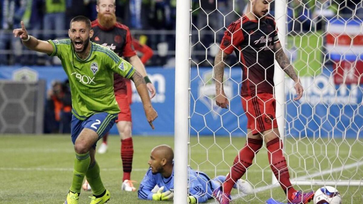 FILE - In this April 26, 2015, file photo, Seattle Sounders' Clint Dempsey, left, celebrates after he scored a goal against Portland Timbers goalkeeper Adam Kwarasey, second from right, as Timbers' Alvas Powell, right, stands in the goal during the second half of an MLS soccer match in Seattle. The Timbers host the Sounders on Sunday in the 100th meeting between the two rivals from the Pacific Northwest. (AP Photo/Ted S. Warren, File)