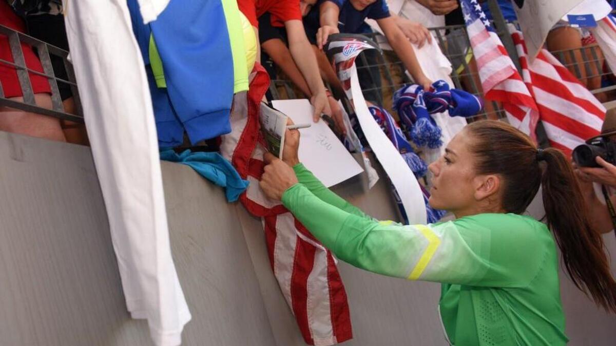 
USA/Seattle Reign goalkeeper Hope Solo (1) signs autographs following a national team women's friendly soccer against Costa Rica last month.

