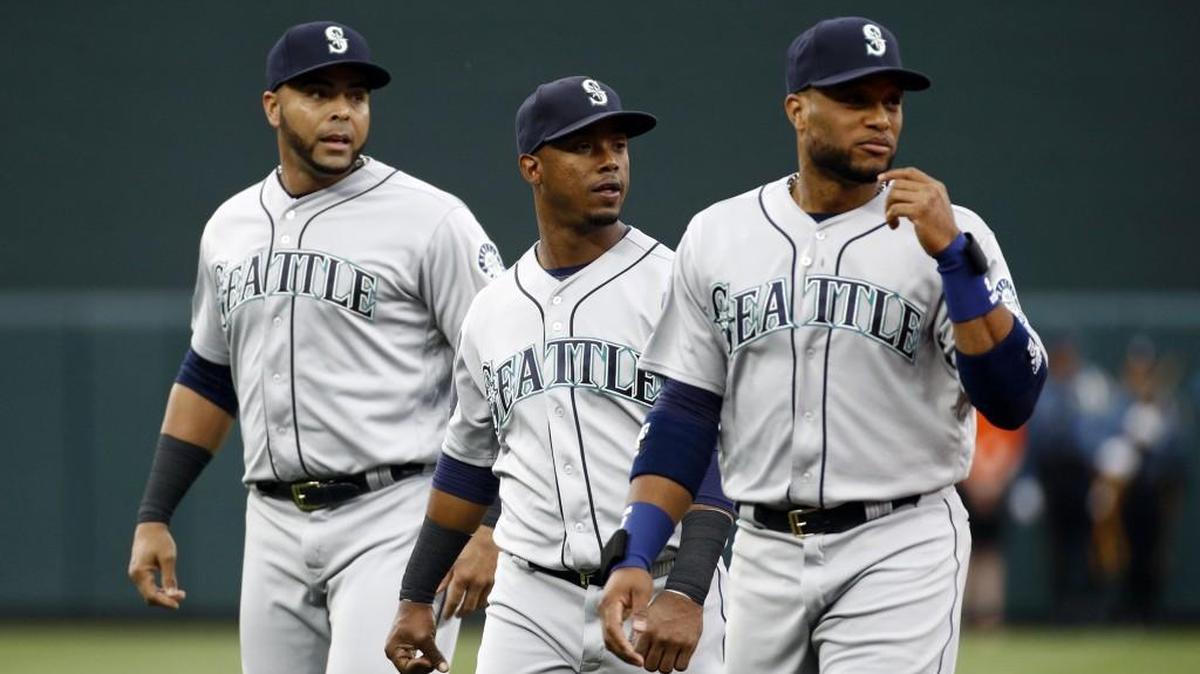 Seattle Mariners' Jean Segura, center, and teammates Nelson Cruz, left, and Robinson Cano will be counted on to anchor a lineup that received two new starters at first base (Ryon Healy) and center field (Dee Gordon).