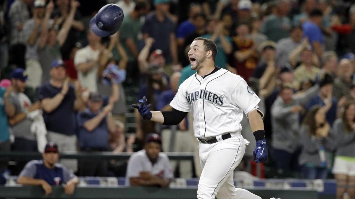 Seattle Mariners’ Mike Zunino tosses his batting helmet as he heads home on his two-run home run, scoring the winning run against the Minnesota Twins in the ninth inning of a baseball game Wednesday, June 7, 2017, in Seattle. The Mariners won 6-5.