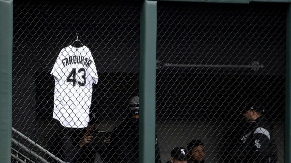 The jersey of White Sox relief pitcher Danny Farquhar hangs in front of the bullpen before a baseball game between the Houston Astros and the Chicago White Sox, Saturday, April 21, 2018, in Chicago. Chicago White Sox reliever Danny Farquhar was taken to the hospital after passing out in the dugout at Guaranteed Rate Field on Friday night. (AP Photo/Nam Y. Huh)