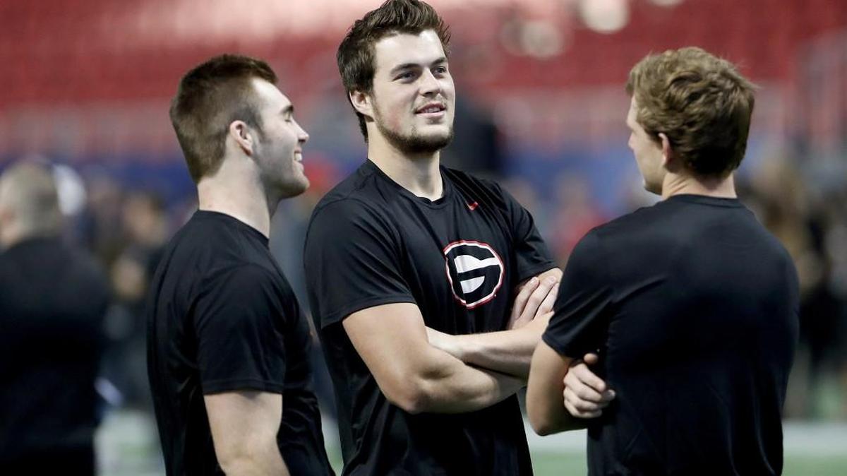 Georgia quarterbacks Jake Fromm, left, and Jacob Eason stand on the field during a walkthrough with teammates ahead of the Southeastern Conference championship in December. Eason has not played for the Bulldogs since injuring his knee in the season opener and appears ready to leave the program.