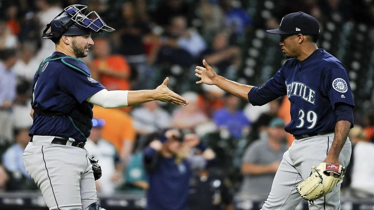 Seattle Mariners relief pitcher Edwin Diaz (39) shakes hands with catcher Mike Zunino following the team’s 4-1 win over the Houston Astros in a baseball game, Wednesday, July 19, 2017, in Houston.