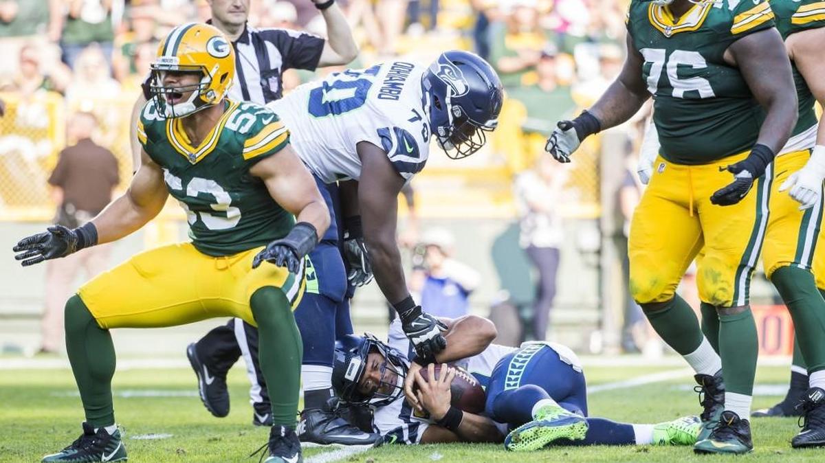 Seattle Seahawks offensive guard Rees Odhiambo helps up Seahawks quarterback Russell Wilson after he is sacked for a loss of 10 yards by Green Bay Packers outside linebacker Nick Perry in the season opener. That game against the Packers showed a lot of the Seahawks’ weaknesses.
