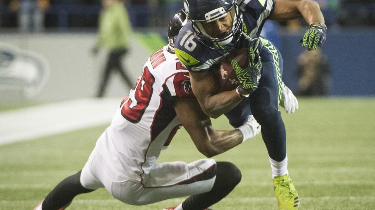 Seahawks wide receiver Tyler Lockett is tackled by Falcons corner back C.J. Goodwin on Monday. Because of his long kickoff returns in the game, Lockett was named as the NFC special teams player of the week.