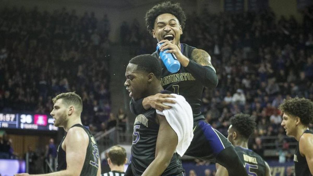 Washington's David Crisp leaps onto Noah Dickerson after UW upset Arizona this season. It will take a few more big moments like that one to get the Huskies into the NCAA Tournament.