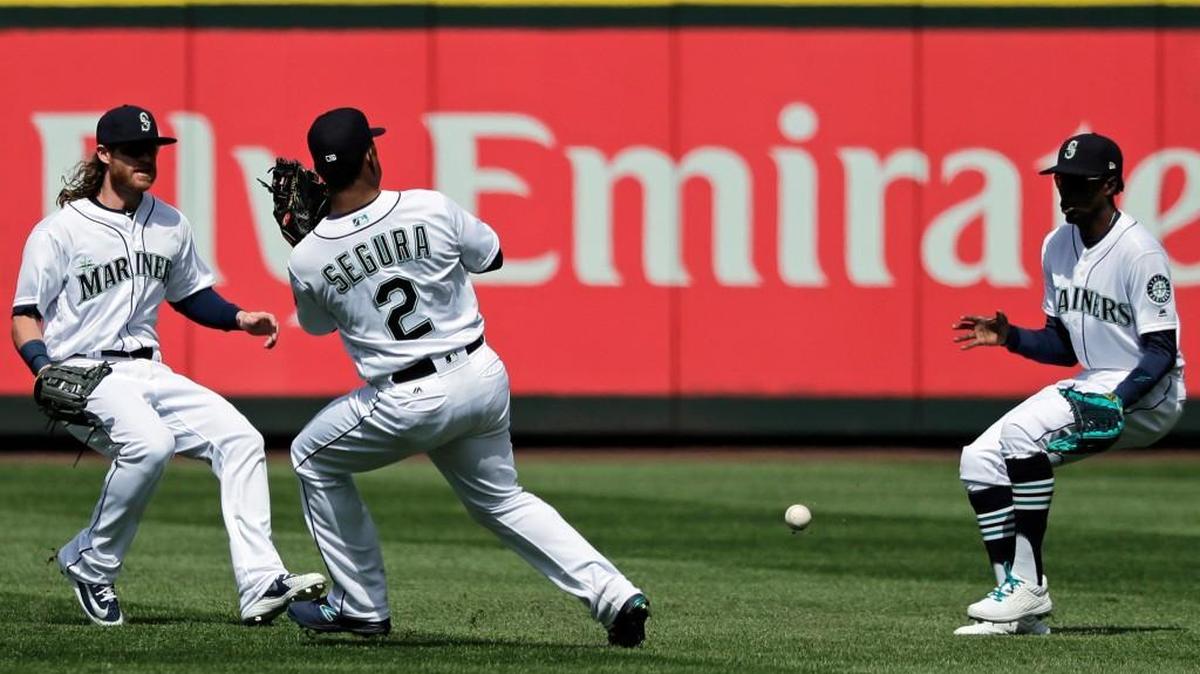 Against the defending World Series champions, you need some luck ... .and good defense. On this play, the Mariners got neither. Center fielder Dee Gordon, right, moves to field a ball hit by Houston Astros' Josh Reddick as Ben Gamel, left, and Jean Segura look on during the fifth inning on Thursday.