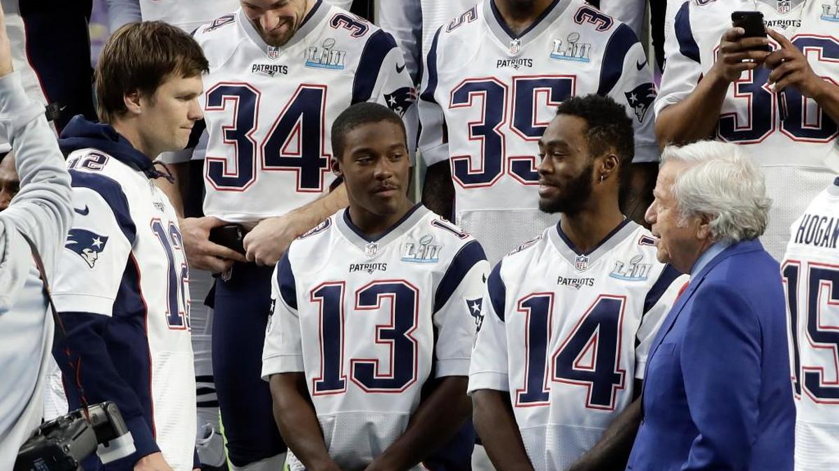 New England Patriots owner Robert Kraft, right, talks with quarterback Tom Brady (12), wide receiver Phillip Dorsett (13) and wide receiver Brandin Cooks (14) before the team photo is made at U.S. Bank Stadium on Feb. 3, 2018, in Minneapolis.