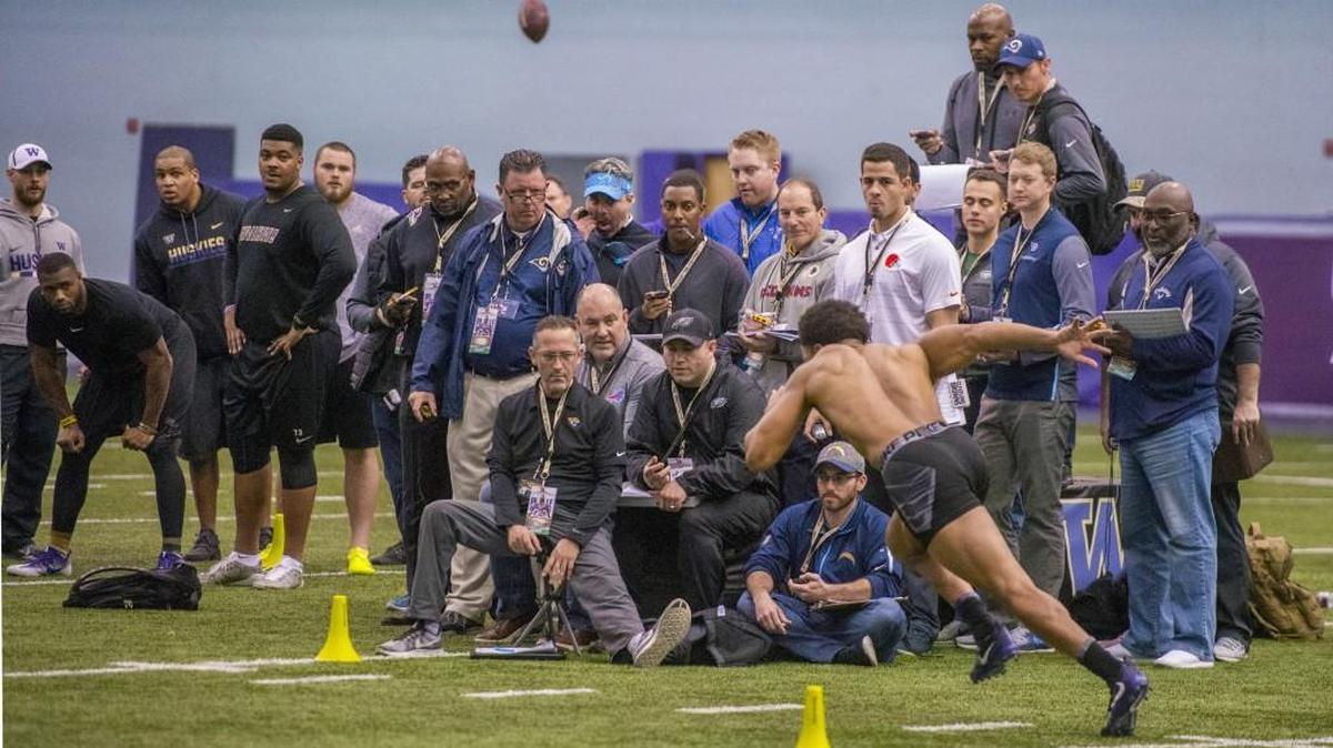 As pro football scouts measure his time, Ezekiel Turner runs a shuttle drill at Pro Day for draft-eligible seniors at University of Washington, March 10, 2018.