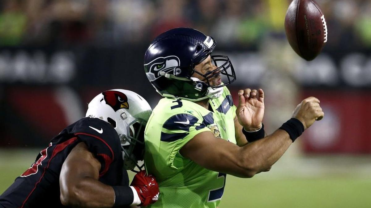 Seattle Seahawks quarterback Russell Wilson (3) loses the ball out of bounds as he is hit by Arizona Cardinals inside linebacker Haason Reddick (43) during a Nov. 9, 2017, game in Glendale, Ariz. Wilson left the game for one play after taking a hit to the head, seeming to forego the NFL’s concussion protocol.