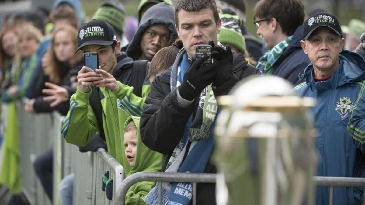 Seattle Sounders fans line up to see the players’ work out and the MLS Cup championship trophy during the opening day of training camp at the Starfire Sports complex Tuesday in Tukwila.
