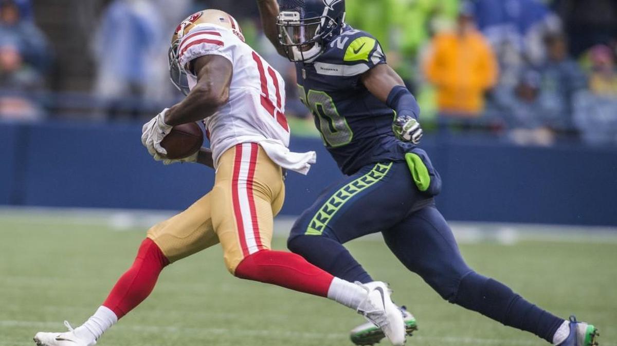 Seahawks cornerback Jeremy Lane, who’ back with the team after an aborted trade to Houston, tries to punch the ball from 49ers receiver Marquise Goodwin back in September.