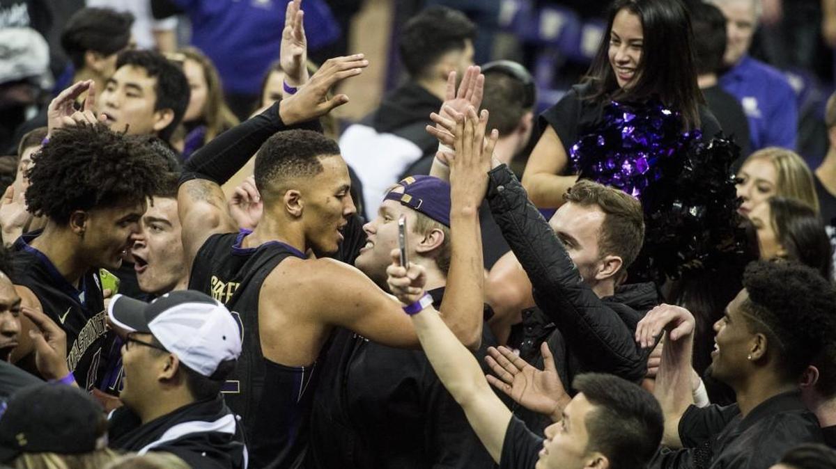 Washington's Dominic Green celebrates with fans after the Huskies beat then-No. 9 Arizona Wildcats at Hec Edmundson Pavilion on Green’s last-second shot.