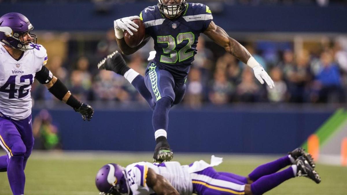 Seahawks running back Chris Carson leaps over Minnesota Vikings defender Jabari Price for a 17-yard gain in the second quarter. But it was his forced fumble on kickoff coverage later that quarter that showed his versatility and willingness to do whatever it takes.